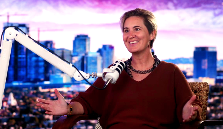 Cristina Dam in conversation at a podcast microphone